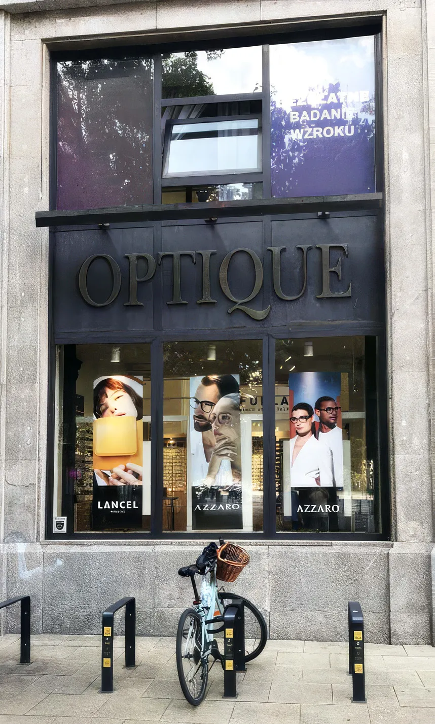 Dimensional OPTIQUE letters above an optician's storefront